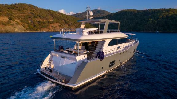 Rear view of the Floki trawler yacht cruising in open sea.