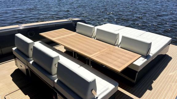 Among Saint Tropez yacht charter options Fortitude motor yacht shows aft deck with large table and seating area.