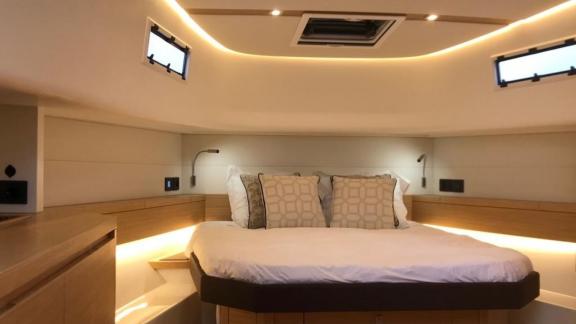 Among Saint Tropez yacht charter options Fortitude motor yacht shows cabin with large bed and ambient lighting.