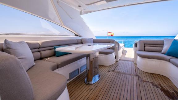 An Ibiza, Spain motor yacht charter lets you relax in the spacious lounge area of the Freedom while enjoying breathtakin