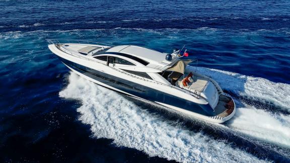 The motor yacht Funky Town impresses with style while cruising swiftly over the blue waters.