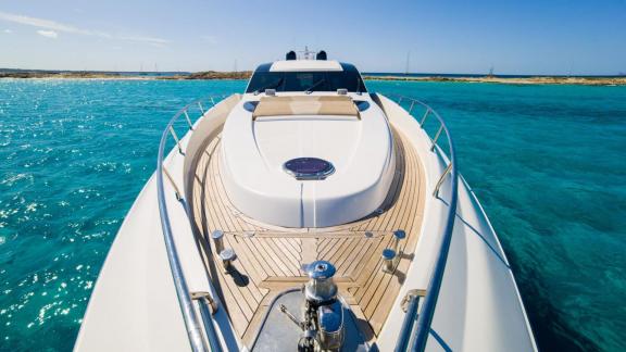 The foredeck of motor yacht Funky Town features a spacious sunbathing area with comfortable cushions.