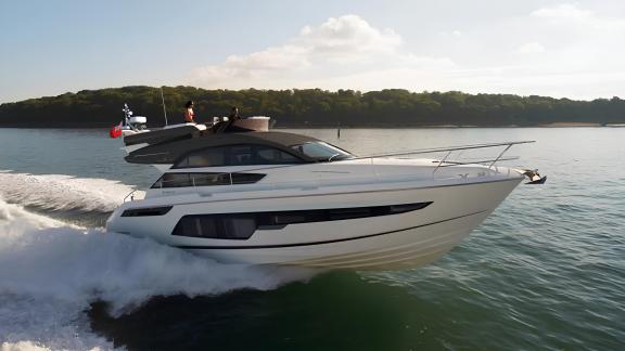 The Get Lucky motor yacht speeding on the open sea. Its elegant design and deck stand out.