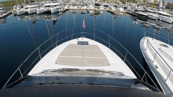 The front deck of the Get Lucky motor yacht is anchored in the marina. Stylish and comfortable seating areas.