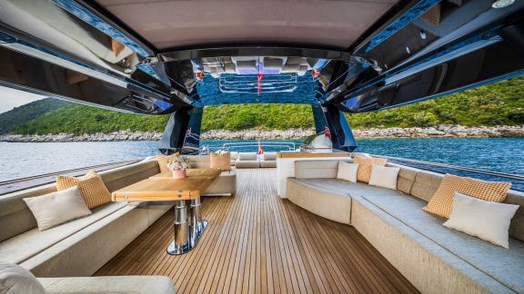 Monte Carlo 86 Giorgio features a spacious flybridge seating area with plush cushions.