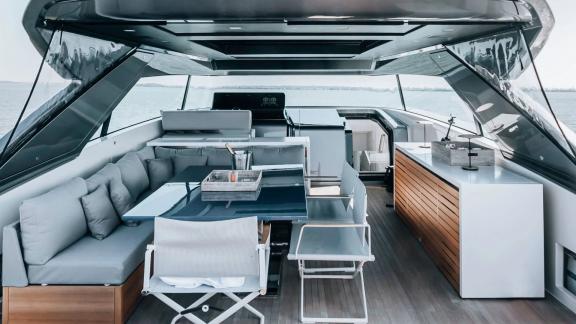 The open lounge area on motor yacht Coco De Mer offers a luxurious experience with comfortable seating and modern design