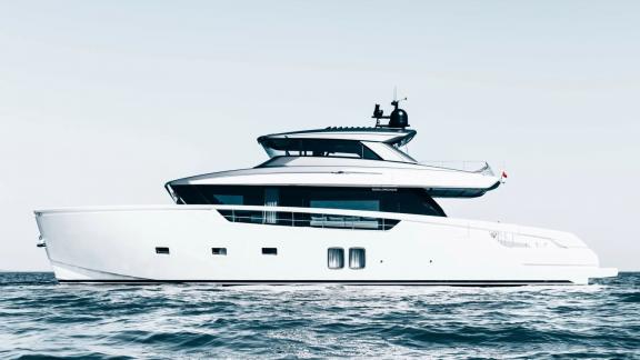 The motor yacht Coco De Mer glides on the water with its elegant side profile and modern design.