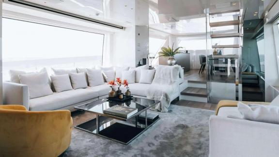 The interior lounge of motor yacht Coco De Mer offers comfort on the water with spacious seating and modern decor.