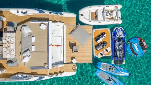 Among Mallorca yacht charter options Gran Abe II shows platform with jet ski and water gear.