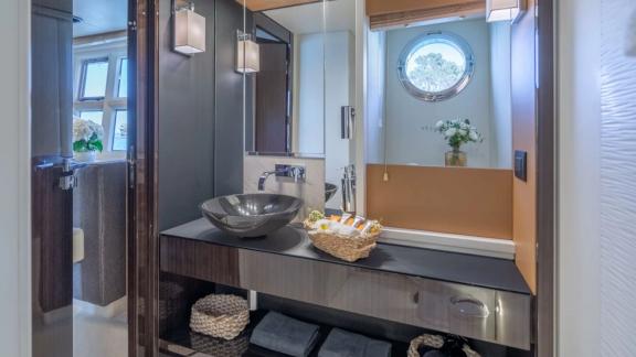 Among Mallorca yacht charter options Gran Abe II shows modern bathroom with sink and shower.