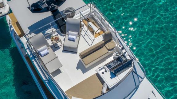 Among Mallorca yacht charter options Gran Abe II shows upper deck lounge and sea view.