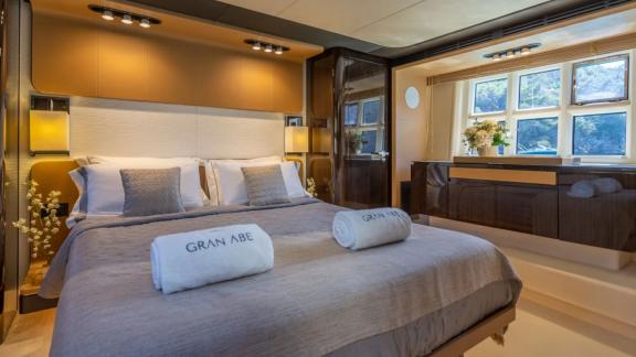 Among Mallorca yacht charter options Gran Abe II shows cozy cabin with bed and storage.