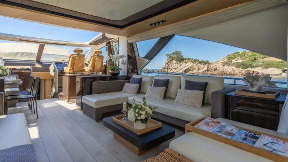 Among Mallorca yacht charter options Gran Abe II shows lounge seating and helm station.