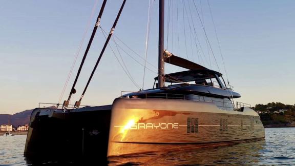 Luxurious Sunreef Catamaran Grayone in Athens on the water at sunset.