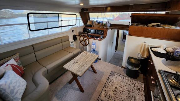 Comfortable interior seating area of motor yacht Grida, along with the helm station.