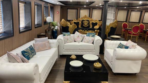 The luxury living room on Harmony II motor yacht offers stylish furniture and a cozy atmosphere.