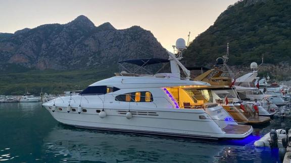 The motor yacht Ibiza offers a luxurious and stylish view at night while moored at the marina in Bodrum.