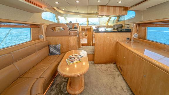 Comfortable seating area and table in the salon of motor yacht İmera.