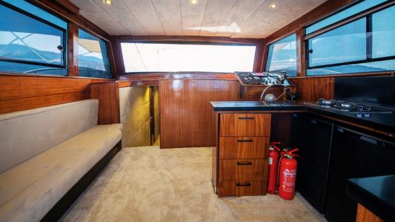 The interior of motor yacht Imperial includes a kitchen and seating area.