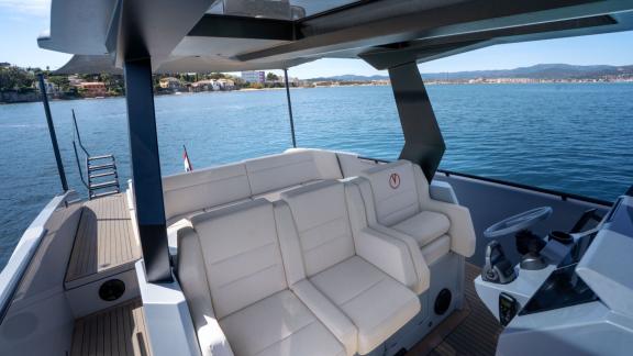Among Saint Tropez private yacht charter options, Je Men Fous is seen with helm seats and a lounge area.