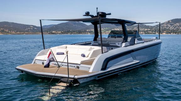Among Saint Tropez day boat rental options, Je Men Fous is seen at anchor with its aft deck.