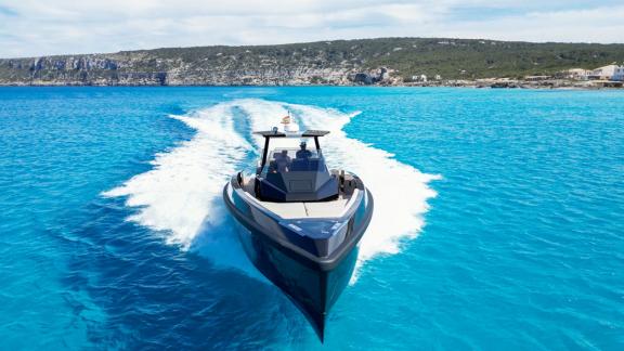 The Jemima motor yacht cruises swiftly through blue waters, showcasing its sleek and modern design.