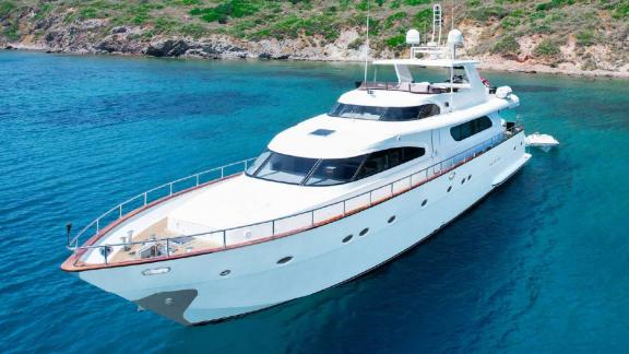 Motor yacht Julem 1 anchored off the coast of Bodrum in the blue sea.