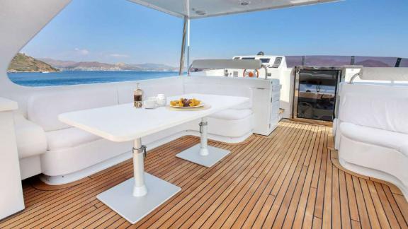 Dining area with sea view on the upper deck of motor yacht Julem 1.