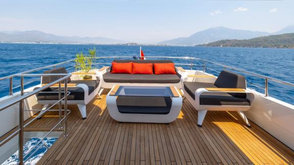 The upper deck of trawler yacht Kaan Bey 2 features a modern and comfortable seating area.