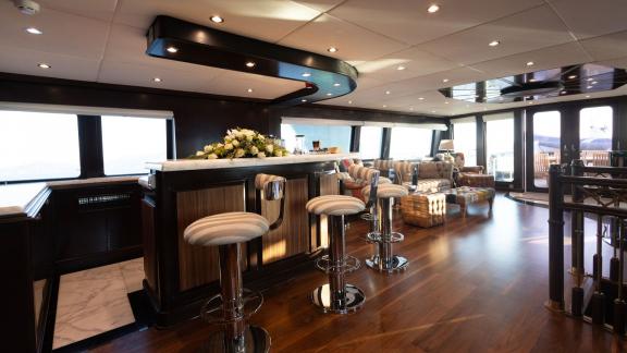 Kokomo Nights features a stylish bar area within the saloon and spacious seating for guests cruising Athens.