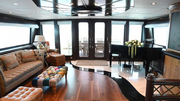 Kokomo Nights features an elegant main saloon with a piano and refined living spaces for guests in Athens.
