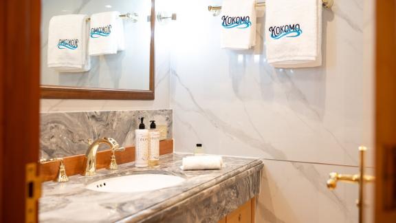 Kokomo Nights features a marble finished bathroom with an elegant vanity area and refined onboard comfort.