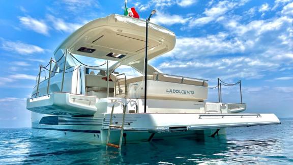 An Italy, Naples motor yacht charter lets you enjoy easy sea access and relaxation on the spacious swim platform of La D