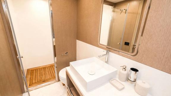 The guest bathroom on yacht La Luna is designed with a simple sink and modern accessories.