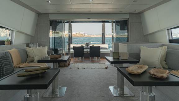 The salon of motor yacht La Romana offers a spacious living area leading to the aft deck.