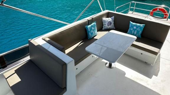 Upper deck seating area of motor yacht Labarna in Göcek, offering a comfortable retreat with cozy cushions.