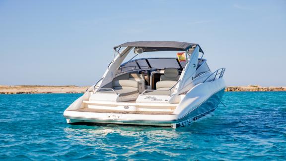 The rear of the Lady Boss motor yacht is anchored on crystal-clear waters.