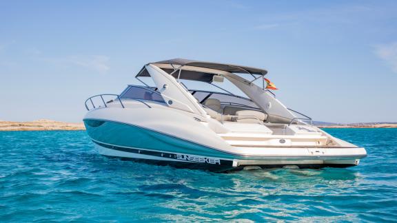 The Lady Boss motor yacht is anchored in crystal-clear waters, with all details clearly visible.