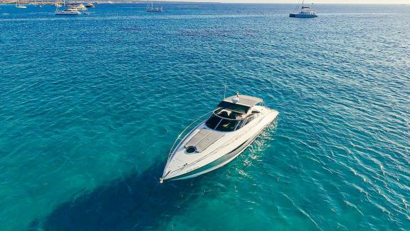 The Lady Boss motor yacht is anchored in calm and crystal-clear waters.