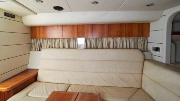 The interior of the Lady Boss motor yacht features a stylish and comfortable seating area with leather couches.