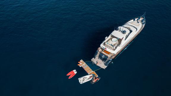 Among Ibiza luxury yacht charter options, Lady KC is seen from above with water toys alongside.