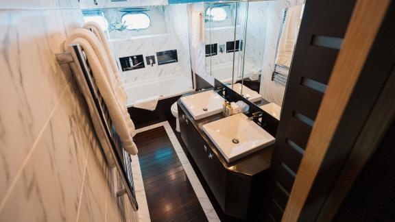 Among Ibiza private yacht charter options, Lady KC is seen with a spacious master bathroom and double sinks.