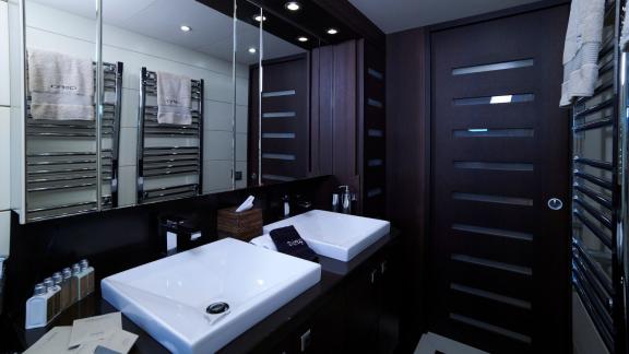 Stylish bathroom featuring double sinks and large mirrors on the motor yacht Lady KC.