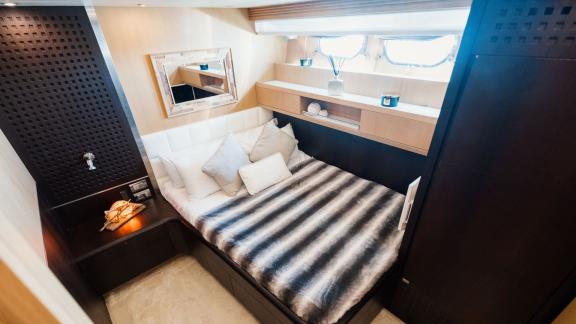 Among Ibiza weekly yacht charter options, Lady KC is seen with an elegant guest cabin featuring a large bed.