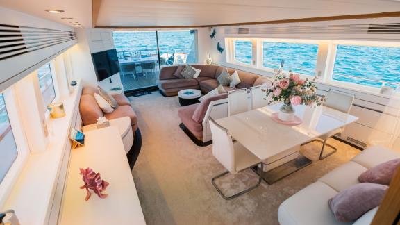 Among Ibiza private yacht holiday options, Lady KC is seen with a spacious salon and dining area.