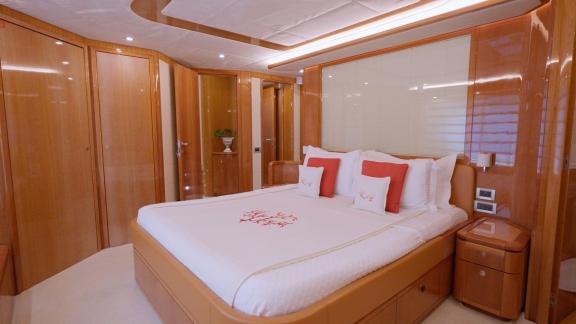 Among motor yacht rental options in Rhodes Lady Natassa master cabin with large bed and storage is seen onboard.