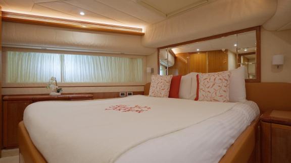 Among motor yacht rental options in Rhodes Lady Natassa cabin with bed and large window offers a bright onboard space.
