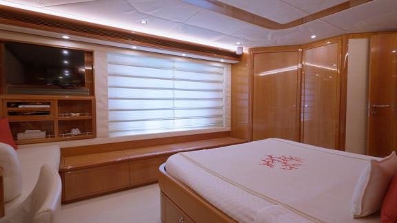 Among motor yacht rental options in Rhodes Lady Natassa cabin with bed storage and window is seen onboard.