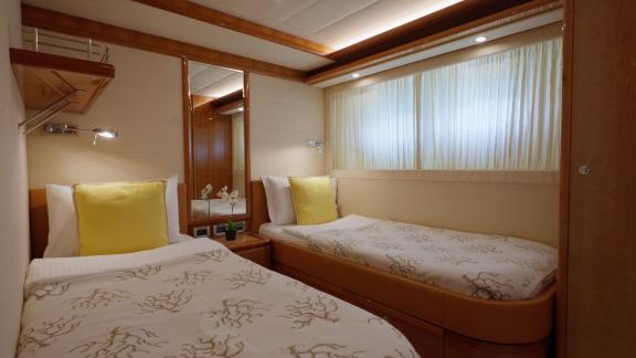 Among motor yacht rental options in Rhodes Lady Natassa twin cabin with two beds and window offers a cozy onboard space.