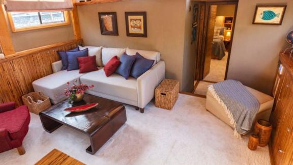 Stylishly furnished living room with a comfortable couch and modern decor on a yacht.